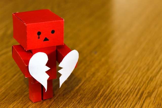 a robot holding a divided heart shape
